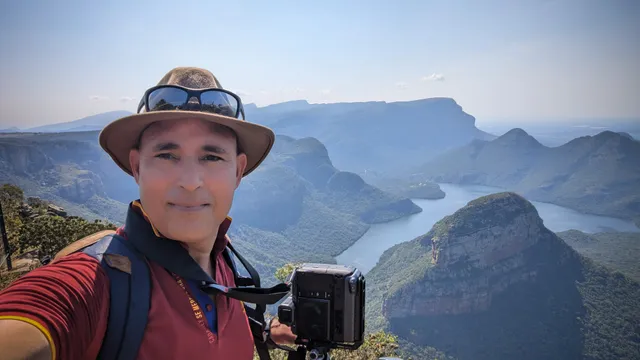 Arnold at a Blyde River Canyon viewpoint, medium-format camera in hand