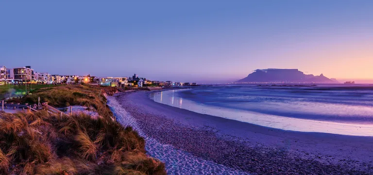 Table Mountain seen across the bay from Bloubergstrand at dusk, Cape Town, South Africa