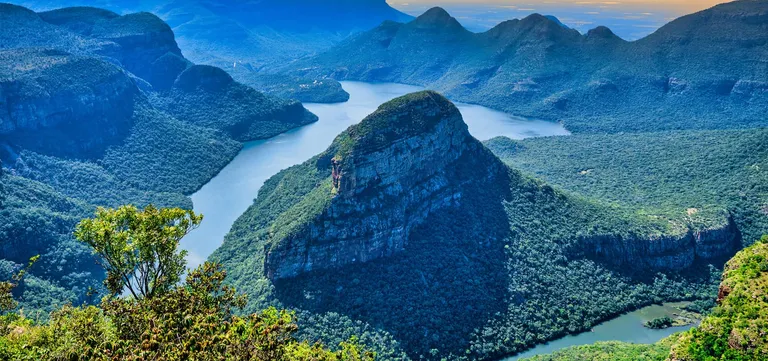 The Blyde River Canyon's forested peaks rising above the Blydepoort Dam, Mpumalanga