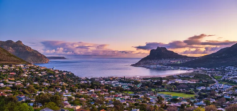 Hout Bay's harbour and beach beneath the mountains on the Cape Peninsula, South Africa