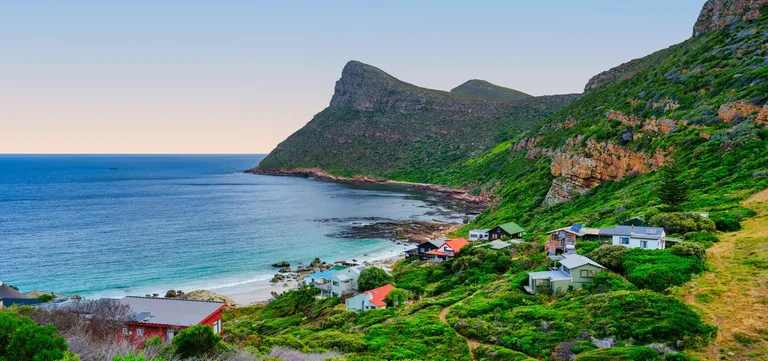 The cottages of Smitswinkel Bay above their secluded cove on the Cape Peninsula, South Africa