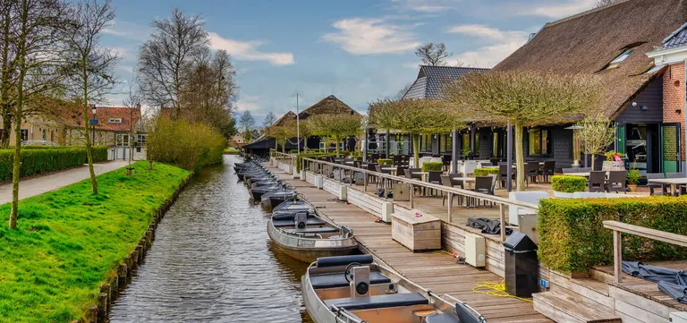 A canal-side restaurant terrace overlooking the water in Giethoorn, Netherlands