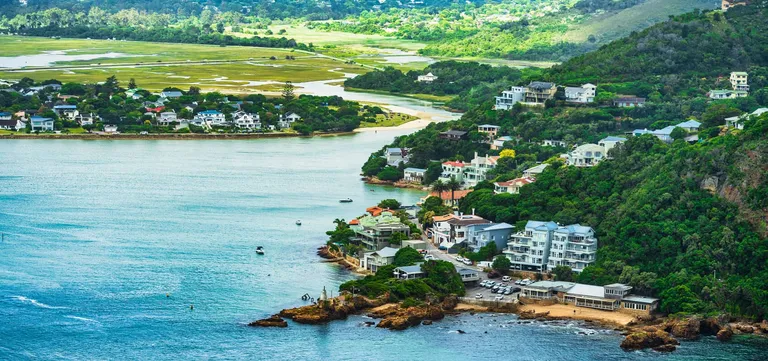 Homes clustered beneath the Eastern Head at the mouth of the Knysna Lagoon, Garden Route, South Africa
