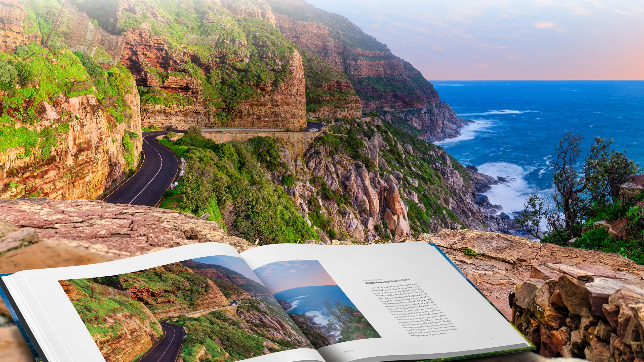 Edge of the Continent open at the Chapman's Peak spread, resting on a stone wall above the road where the photograph was taken