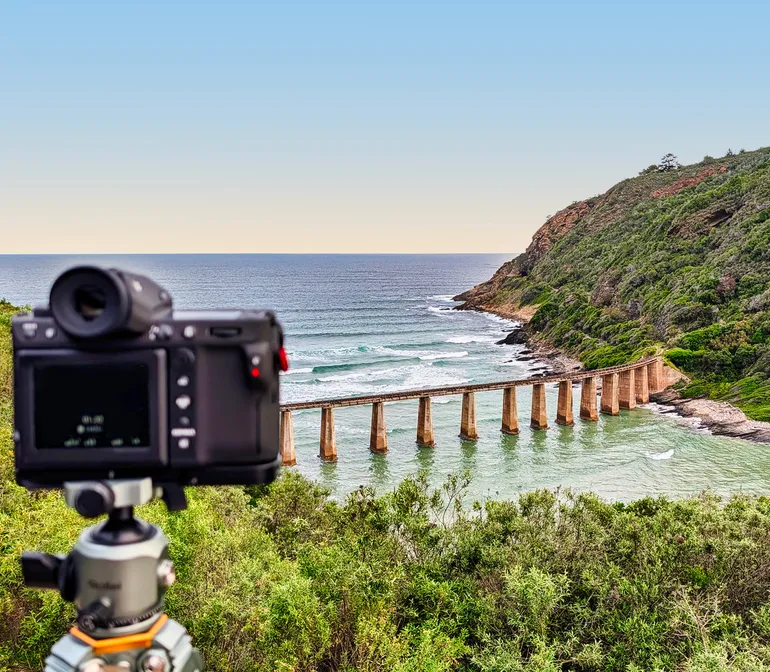 Camera on a tripod overlooking the Kaaimans River railway bridge near Wilderness, Garden Route, South Africa